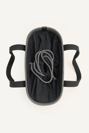 Top view of a gray woven crochet tote bag with black handles on a white background