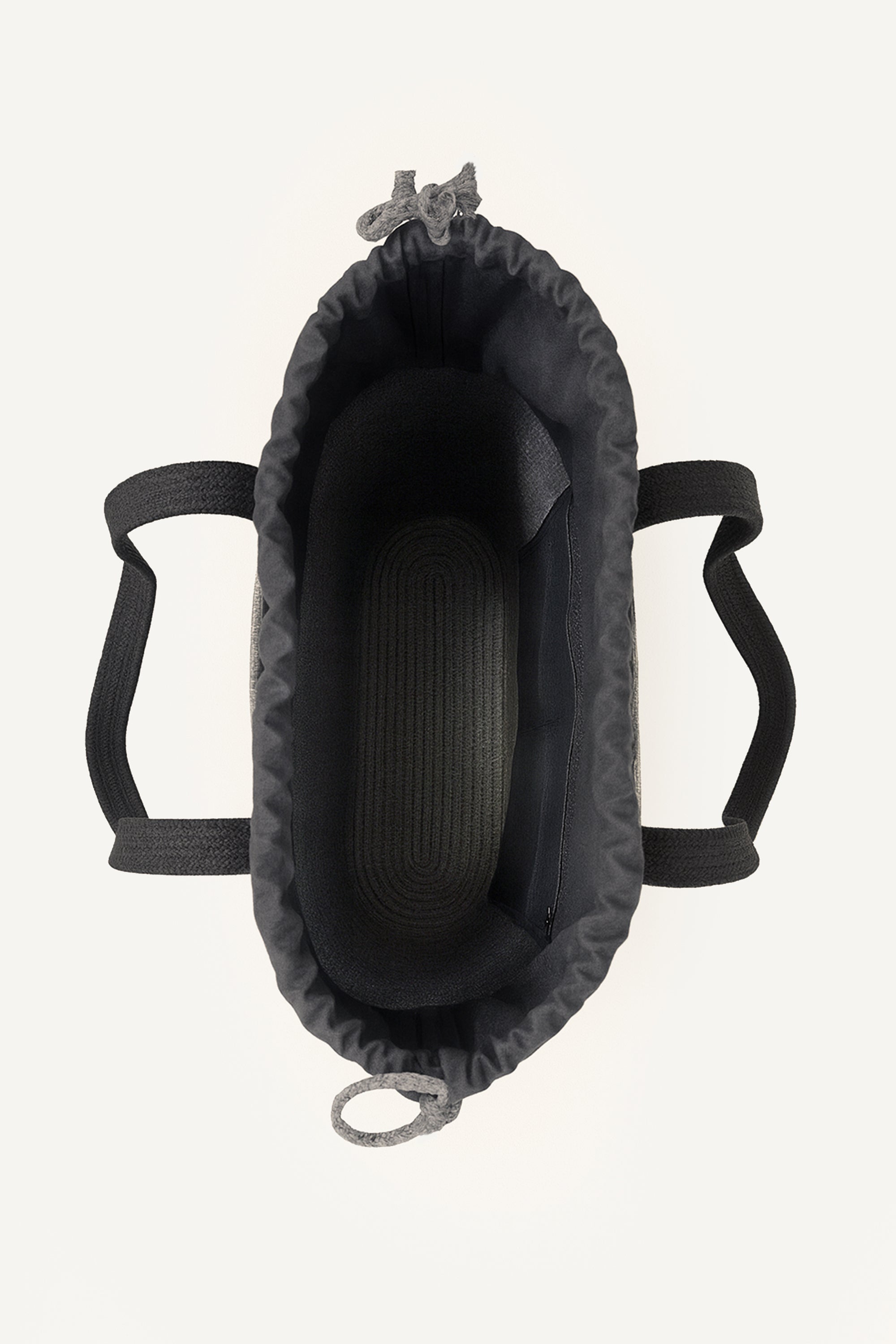 Top view of a gray woven crochet tote bag open showing the inside with black handles