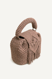 Angled view of the woven brown Assos crochet top-handle bag with fringe detailing