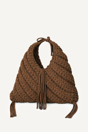 Front view of Lviv crochet brown woven handbag with tassels on a light beige background
