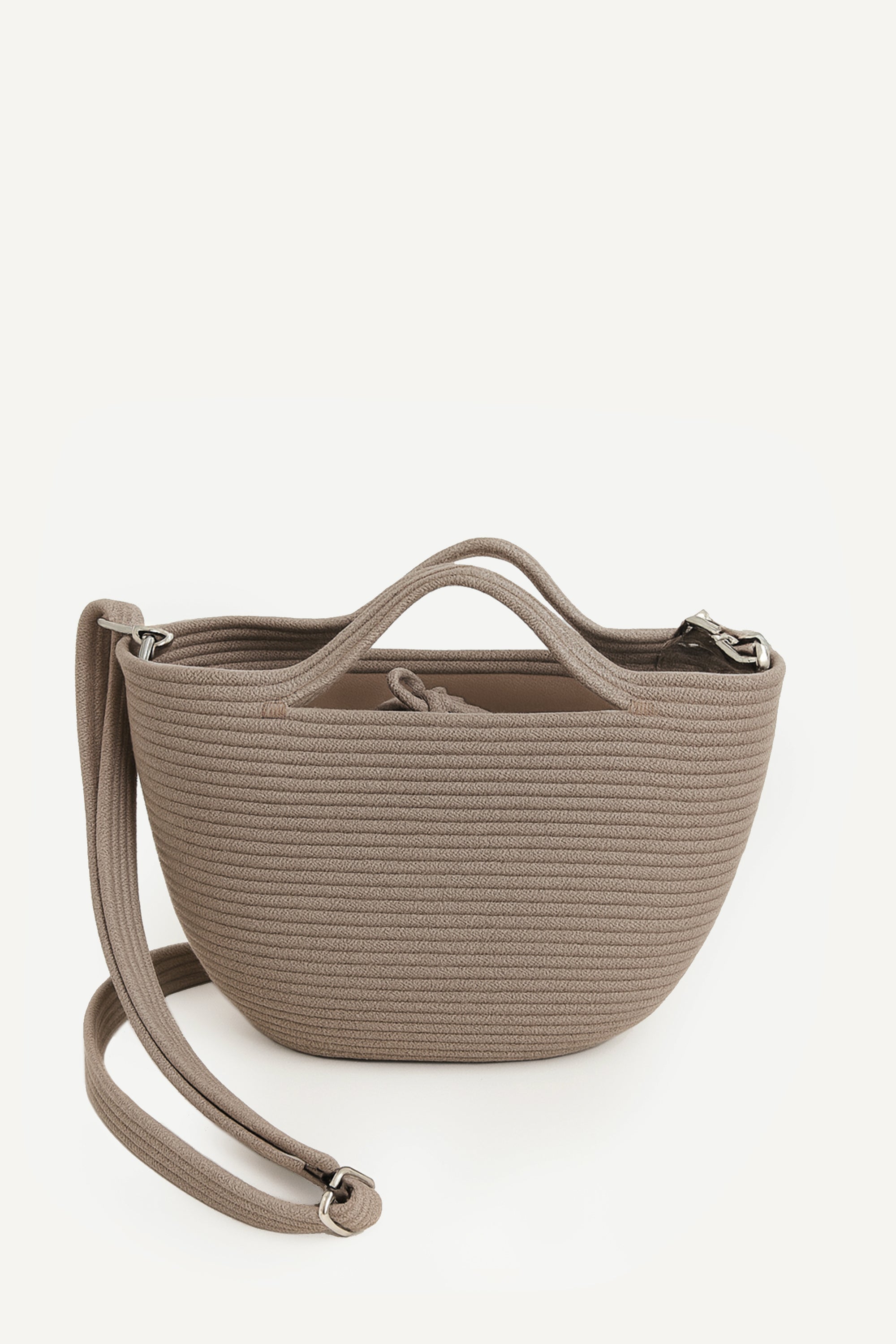Front view of the beige capri cotton crochet crossbody bag with an adjustable strap and secure drawstring closure