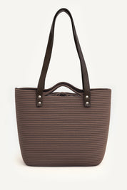 Front view of the brown woven capri tote bag with leather handles on a white background