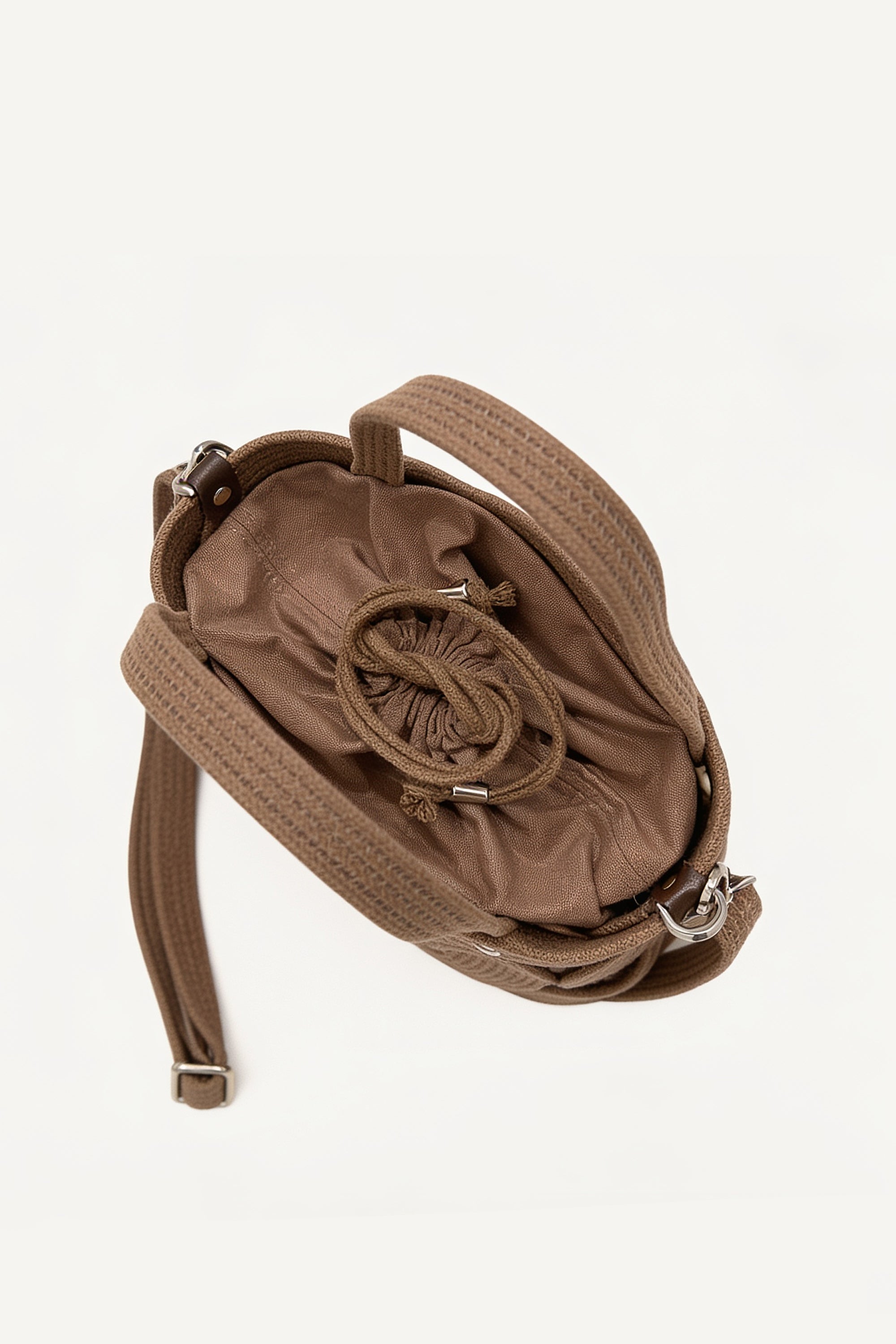 Top view of the brown elba cotton crochet crossbody bag with an adjustable strap and secure drawstring closure