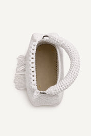 Top view of the woven white assos crochet top-handle bag with fringe detailing