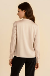 Back view of Charming Blouse by FemeAdor in beige with bowtie detail and flattering drape, ideal for professional and casual styling