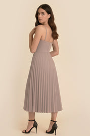 Back view of the Eclipse Demi Dress by FemeAdor in beige featuring a structured corset top and a flowing pleated midi skirt perfect for formal and casual events