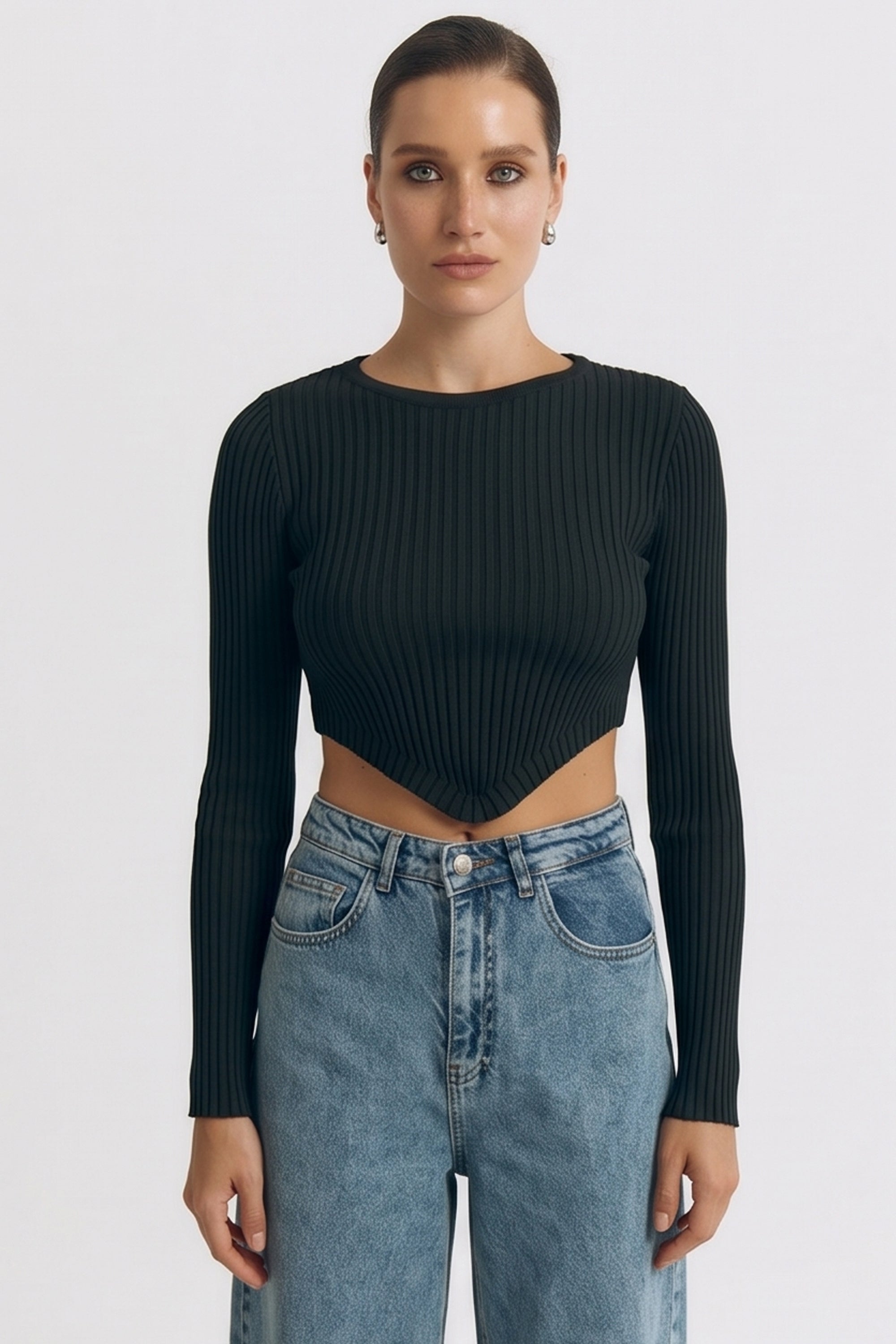 Front view of a woman wearing the black Cropped Longsleeve Top by FemeAdor featuring a flattering cropped cut and a cozy fitted ribbed knit design