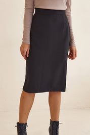 Close up of Liaison Skirt by FemeAdor in black featuring a sleek, figure-flattering midi silhouette, ideal for both professional and casual styling