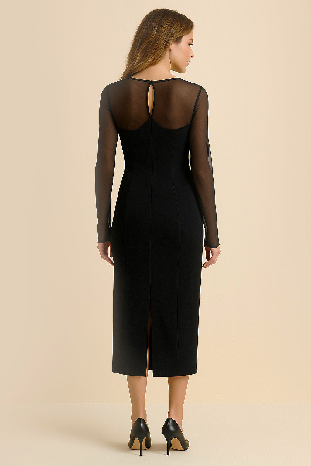 Back view of the Noir Midi Dress by FemeAdor in black featuring a sheath silhouette and sheer front insert for an elegant, modern look