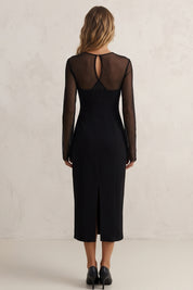 Back view of a woman wearing the black noir midi dress by FemeAdor featuring a sheath silhouette and sheer front insert for an elegant, modern look