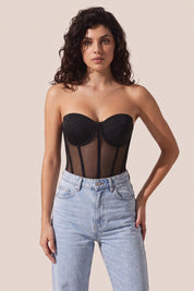 Front view of a woman wearing the black Timeless Corset by Femeador with a structured fit, lace-up back and romantic silhouette