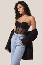 Side view of a woman wearing the black Timeless Corset by Femeador with a structured fit, lace-up back and romantic silhouette