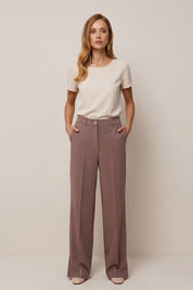 Front view of a woman wearing the brown Continental Trousers by FemeAdor with high-waisted tailored fit, ideal for office or casual wear