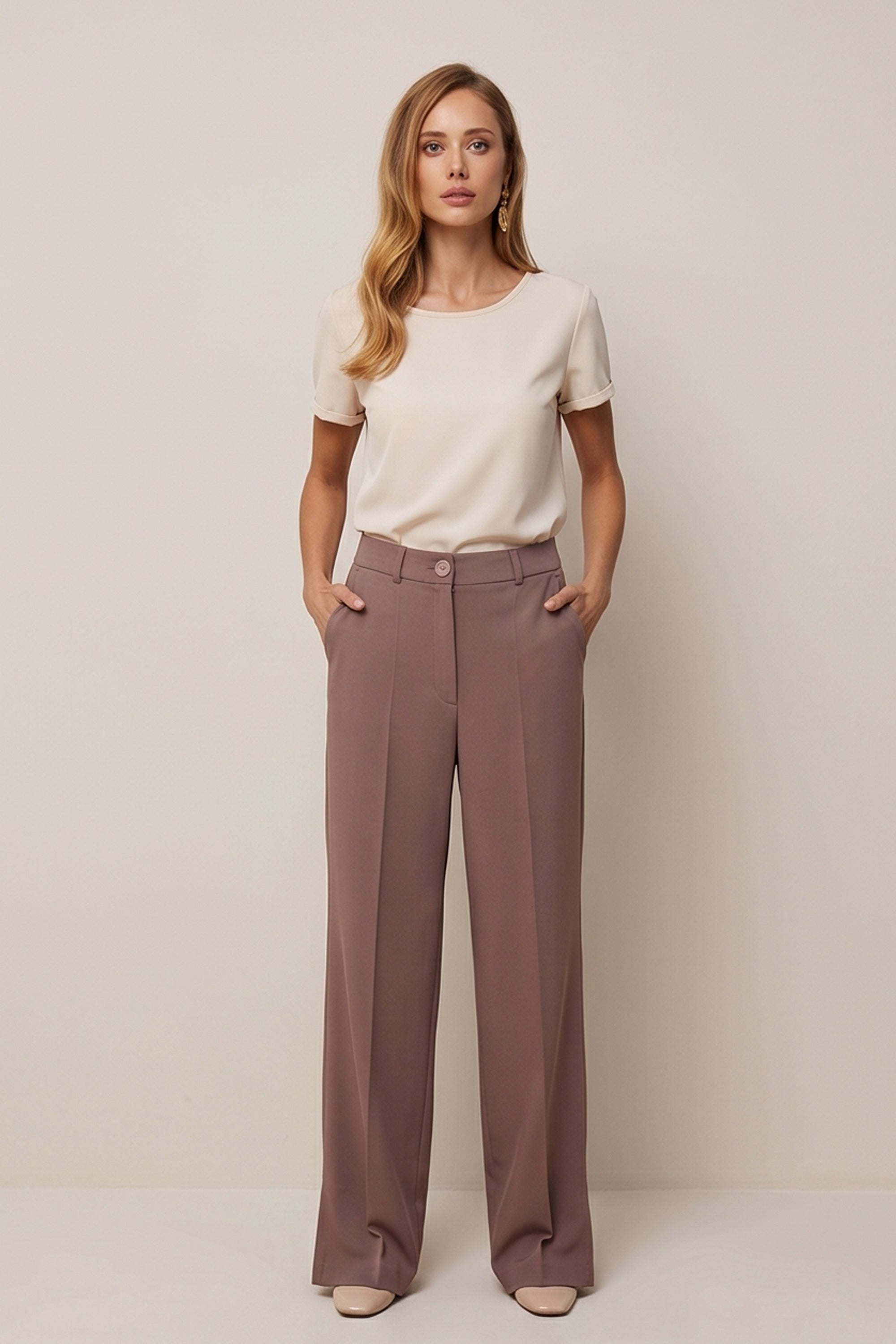 Front view of a woman wearing the brown Continental Trousers by FemeAdor with high-waisted tailored fit, ideal for office or casual wear