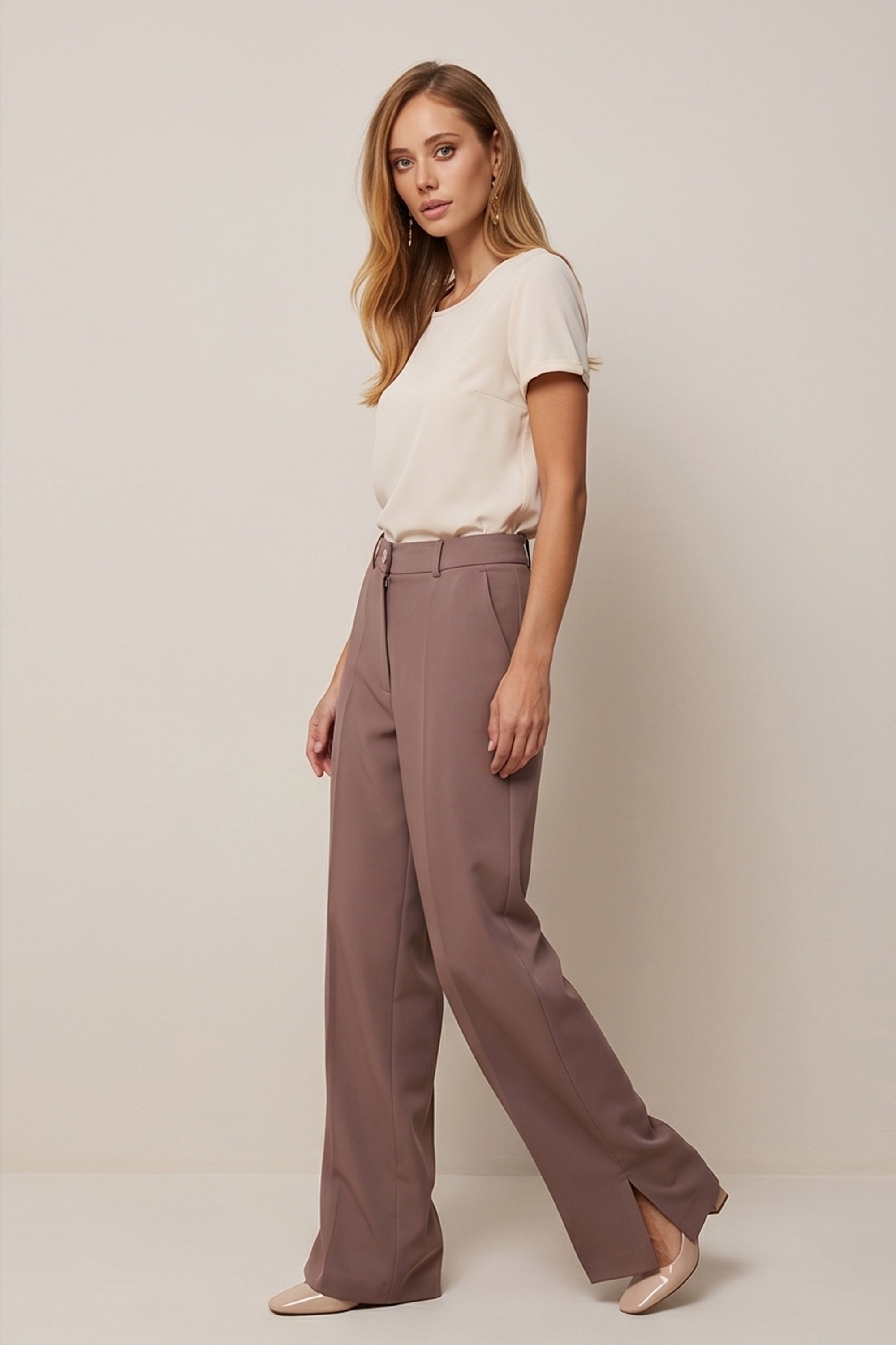 Side view of a woman wearing the brown Continental Trousers by FemeAdor with high-waisted tailored fit, ideal for office or casual wear