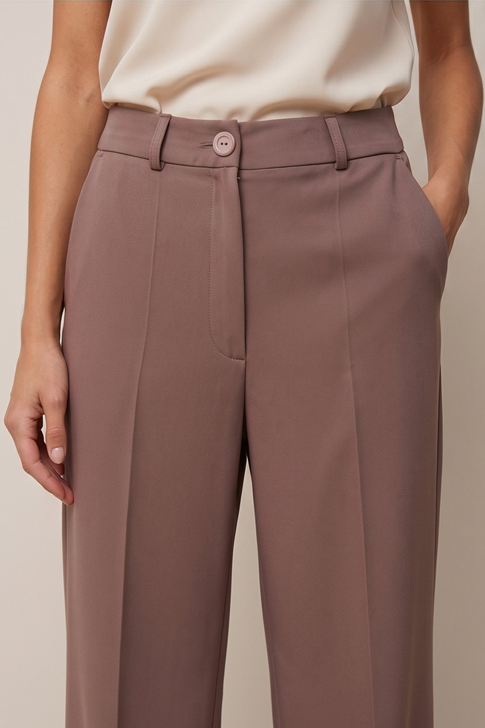 Close up view of a woman wearing the brown Continental Trousers by FemeAdor with high-waisted tailored fit, ideal for office or casual wear