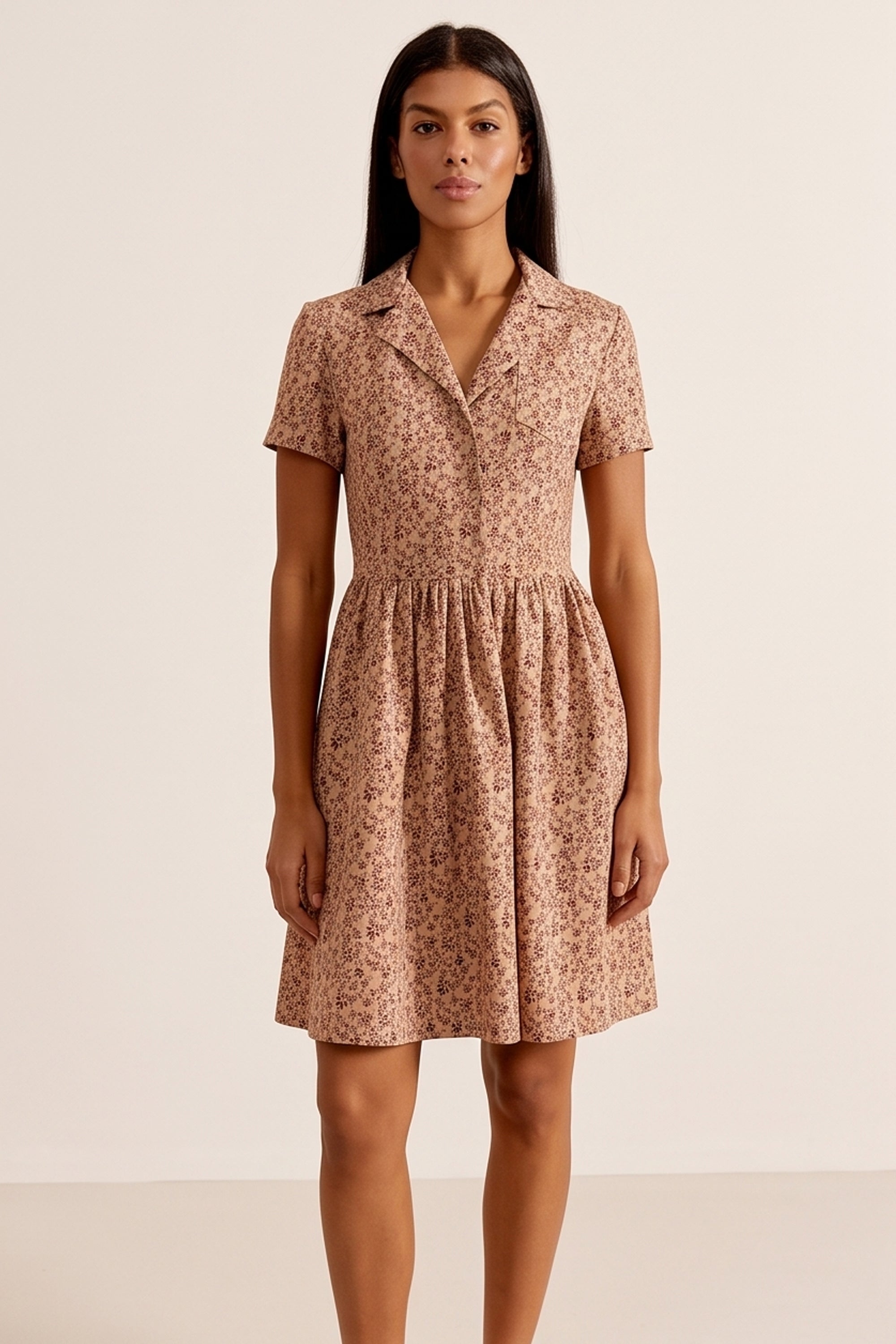 Front view of a woman wearing the brown Mocha Mini Dress in floral linen with short sleeves and collared neck design by FemeAdor