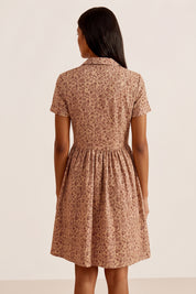 Back view of a woman wearing the brown Mocha Mini Dress in floral linen with short sleeves and collared neck design by FemeAdor