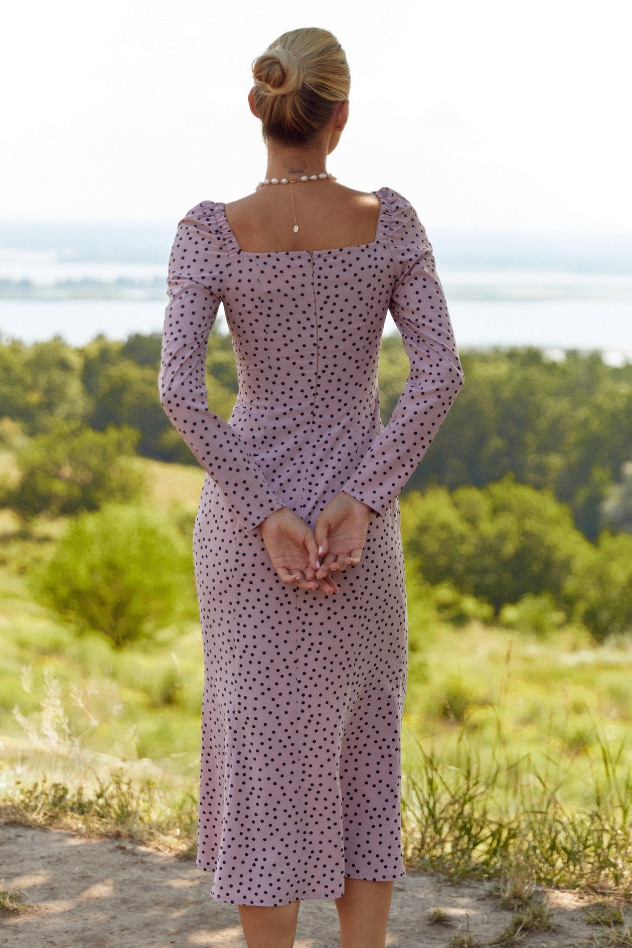 Back view of the Celestra Midi Dress by FemeAdor in pink featuring a flattering fit-and-flare silhouette and timeless polka dot pattern