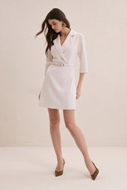 Front view of a woman wearing the cream vespera mini dress-jacket by FemeAdor