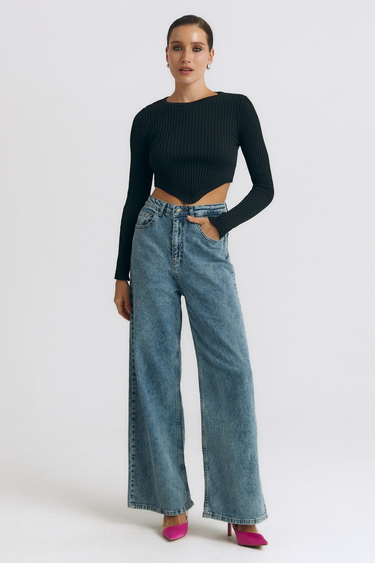 Full body view of the Cropped Longsleeve by FemeAdor in black featuring a flattering cropped cut and a cozy fitted ribbed knit design