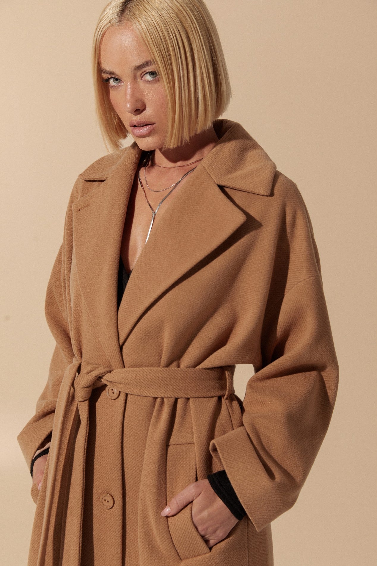 Close up of Elysian Overcoat by FemeAdor in brown with wide lapels and a tailored silhouette, ideal for fall and winter styling