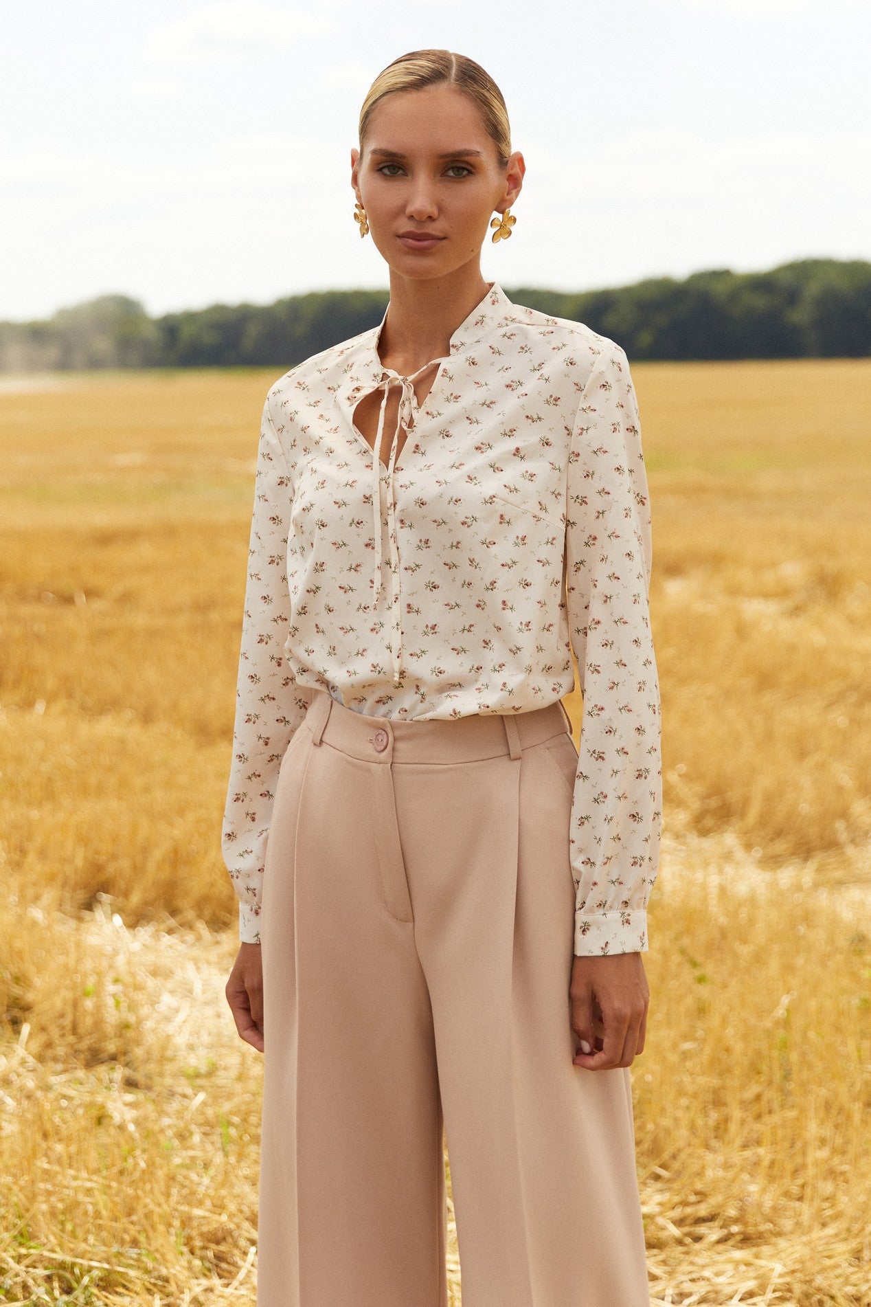 Front view of Floral Blouse by FemeAdor in white featuring a delicate floral print and tie detail, perfect for casual or polished looks