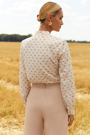 Back view of Floral Blouse by FemeAdor in white featuring a delicate floral print and tie detail, perfect for casual or polished looks
