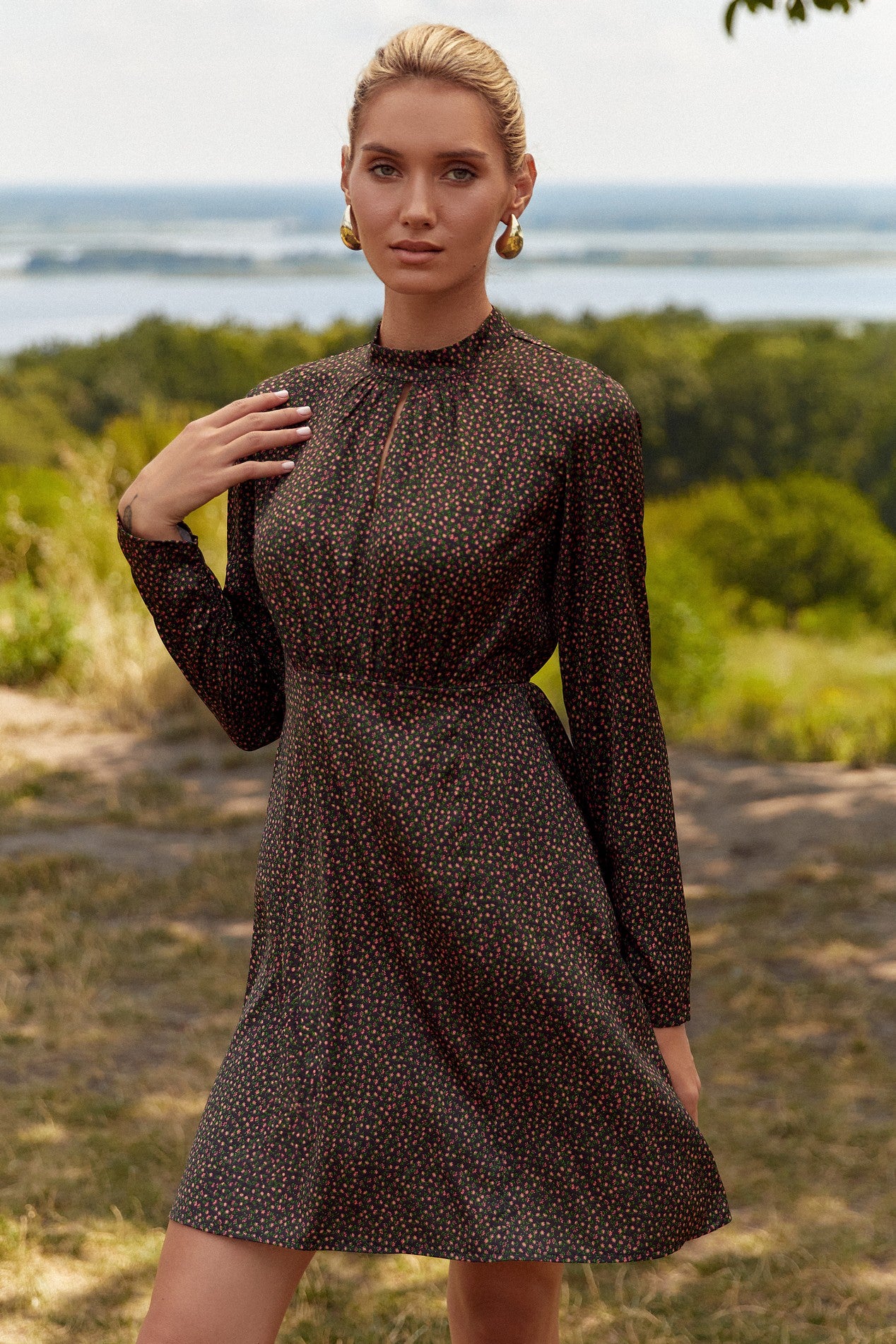 Front view of the Floral Mini Dress by FemeAdor in black with delicate floral print, stand-up collar, and flattering fit