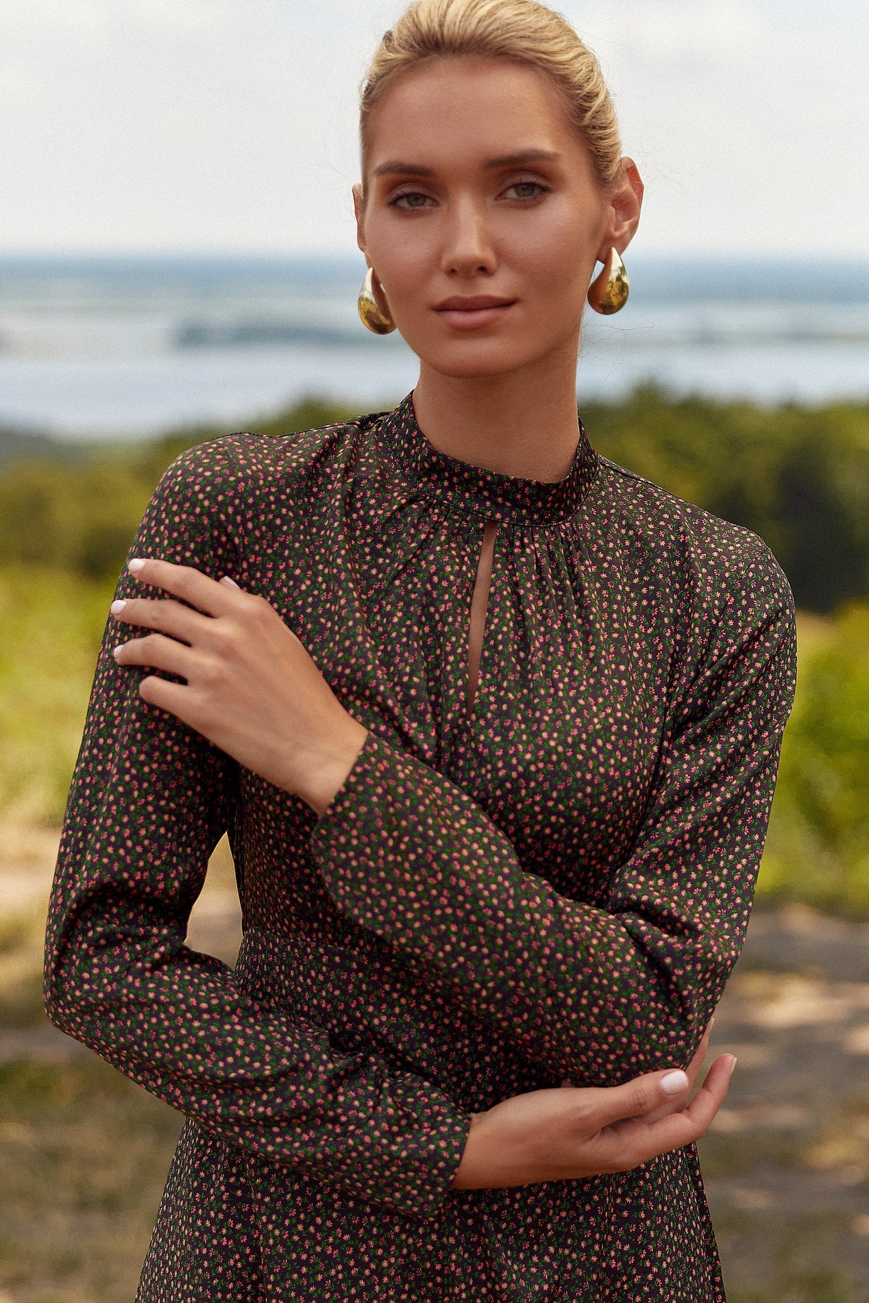 Close up of the Floral Mini Dress by FemeAdor in black with delicate floral print, stand-up collar, and flattering fit