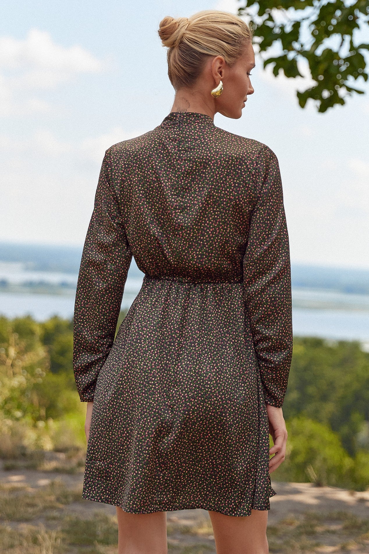 Back view of the Floral Mini Dress by FemeAdor in black with delicate floral print, stand-up collar, and flattering fit