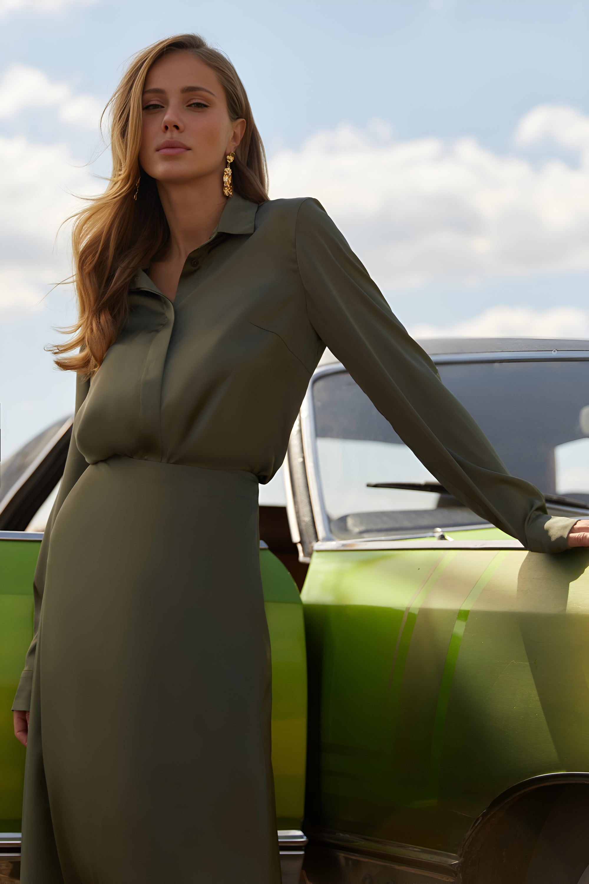 Front view of a woman wearing the Nora Blouse in green satin with silk-like sheen and flattering drape, perfect for work or special occasions