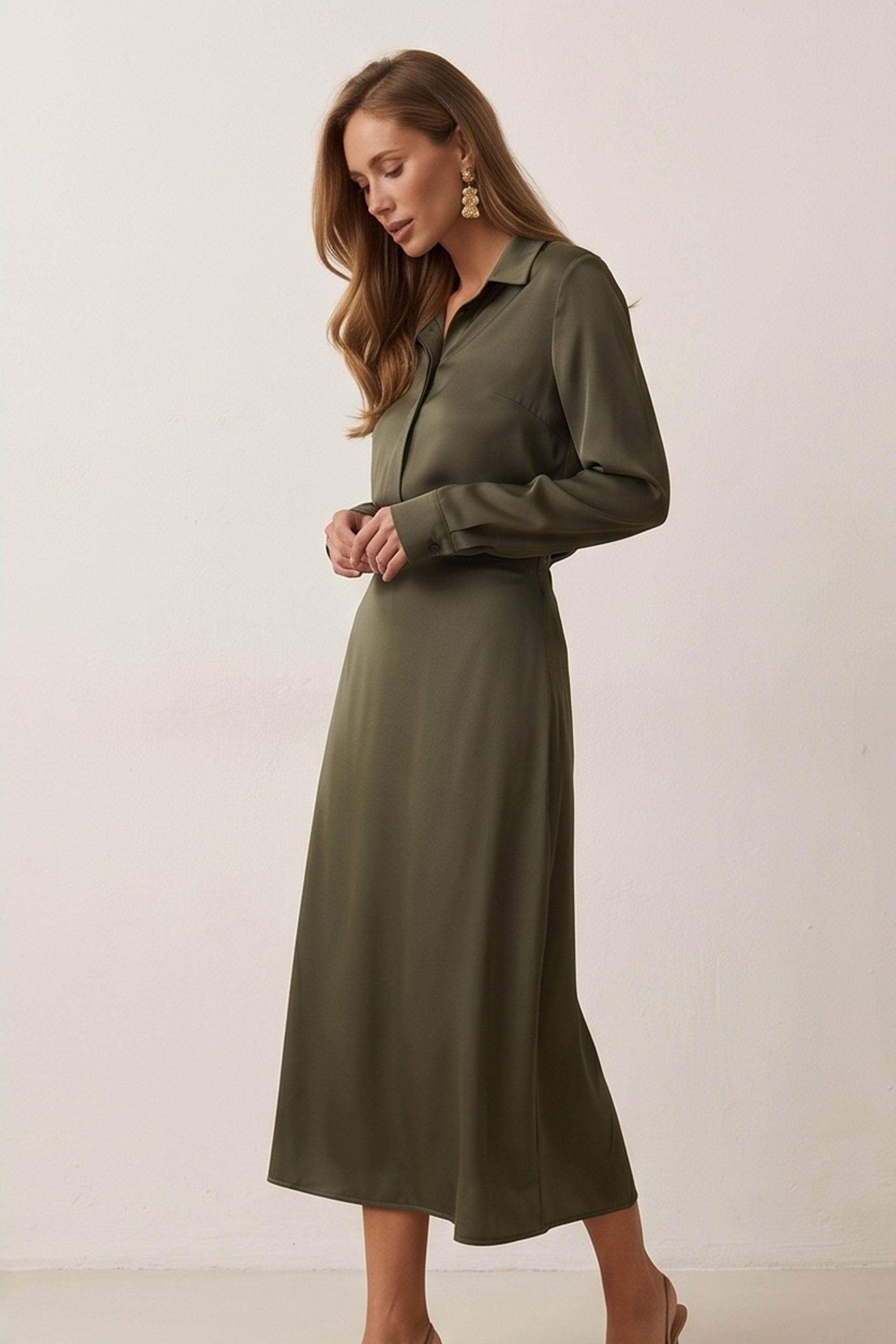 Side view of Nora Skirt by FemeAdor in green featuring a silk-like finish and flattering midi silhouette, ideal for various occasions