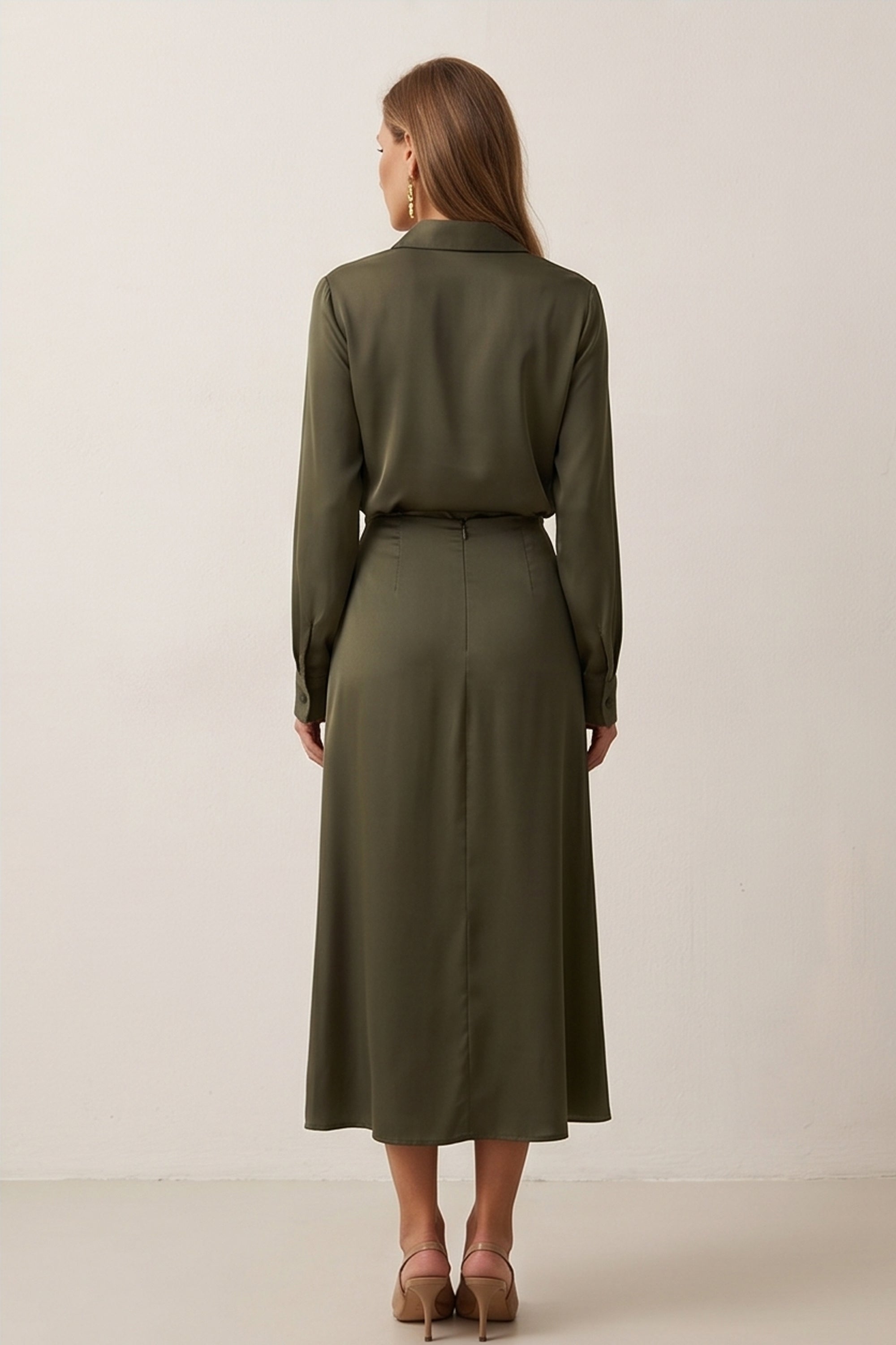Back view of Nora Skirt by FemeAdor in green featuring a silk-like finish and flattering midi silhouette, ideal for various occasions