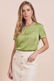Front view of a woman wearing the green Pearl T-shirt by FemeAdor with silk-like finish and relaxed flattering fit
