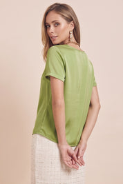 Side view of a woman wearing the green Pearl T-shirt by FemeAdor with silk-like finish and relaxed flattering fit