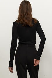 Back view of Knitted Longsleeve by FemeAdor in black featuring a soft, breathable fabric and flattering fit, ideal for layering or wearing on its own