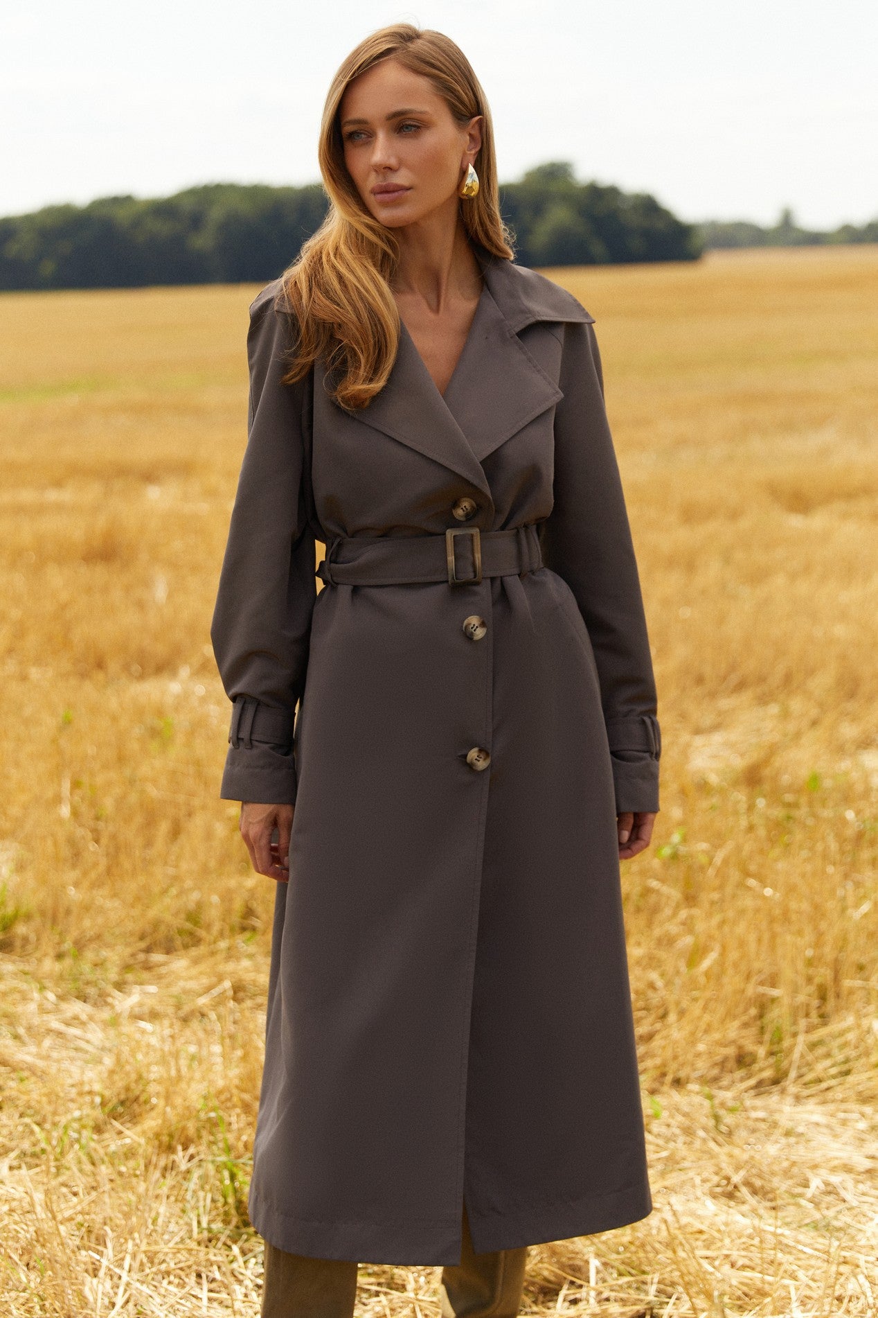 Front view of Luxe Trench Coat by FemeAdor in gray with double-breasted front and belted waist, ideal for professional and casual styling