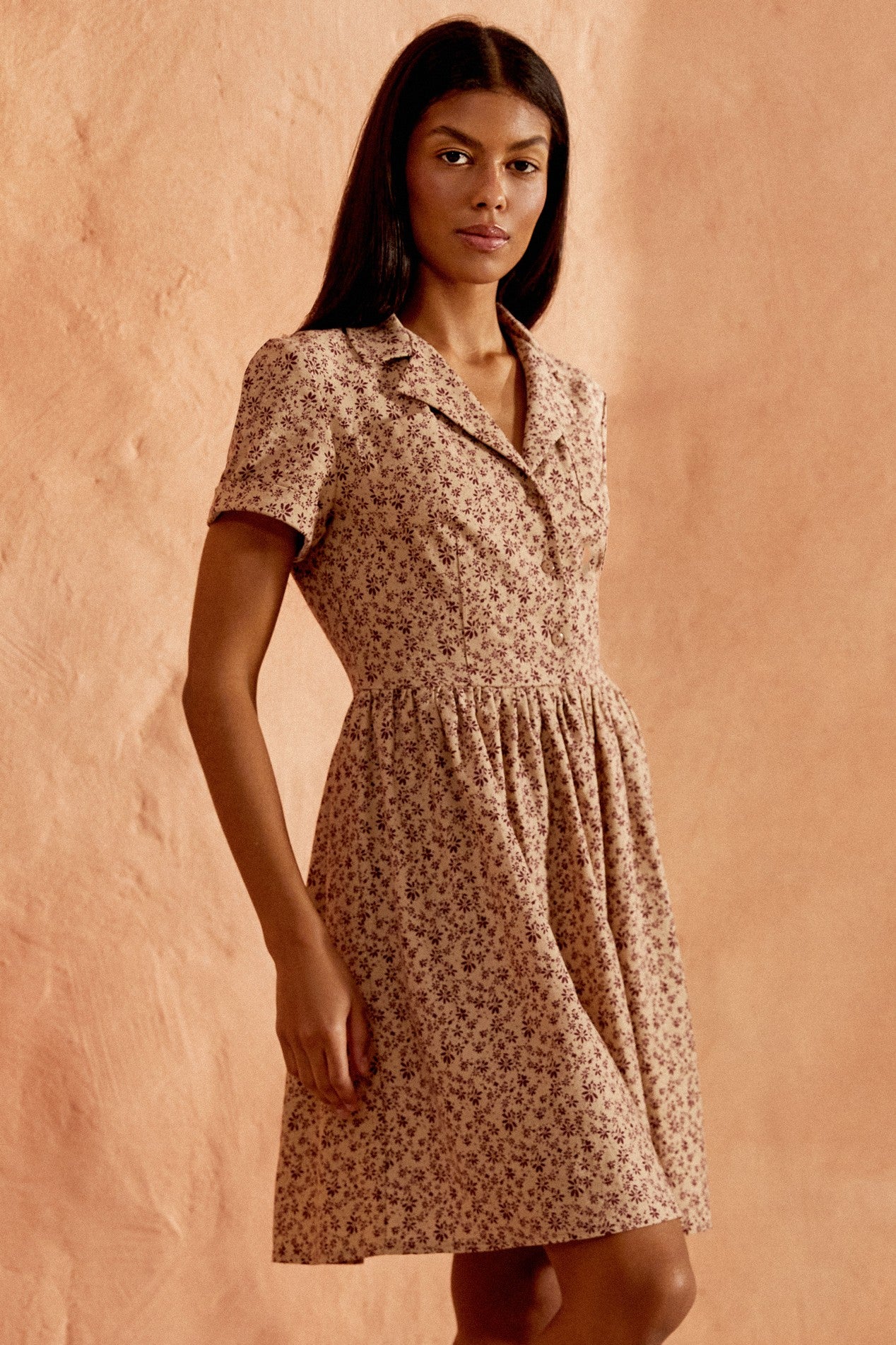 Slight side view of the Mocha Mini Dress in brown floral linen with short sleeves by FemeAdor
