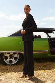 Side view of Moda Trousers by FemeAdor in black featuring a high-waisted, wide-leg tailored fit for modern styling