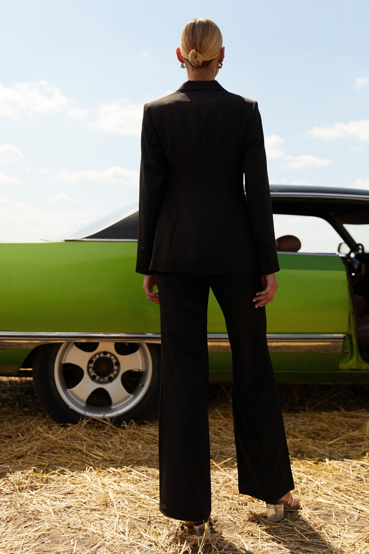 Back view of Moda Trousers by FemeAdor in black featuring a high-waisted, wide-leg tailored fit for modern styling