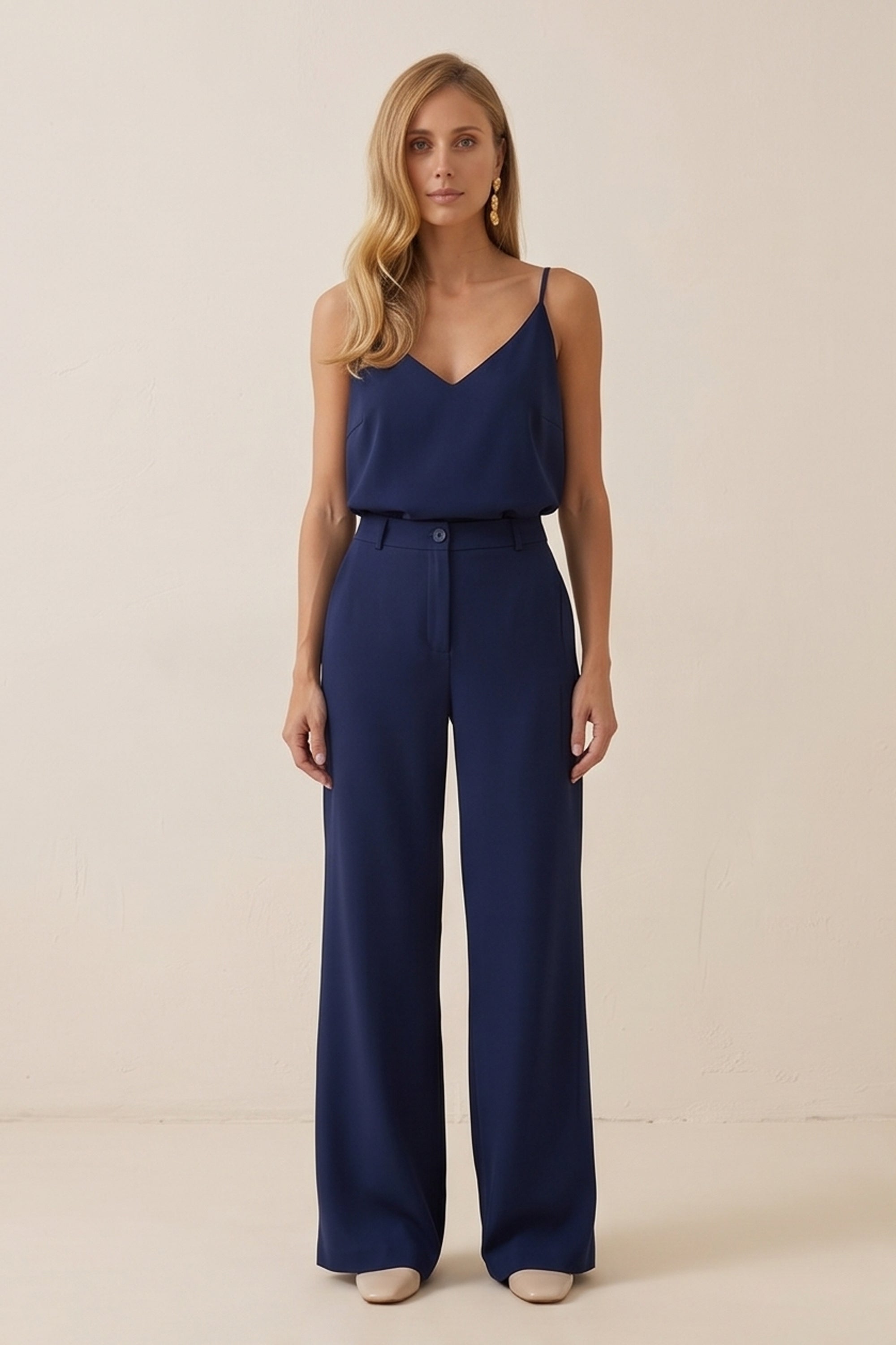 Front view of a woman wearing navy blue Regal Trousers by FemeAdor with high-waisted, wide-leg tailored fit, perfect for professional and casual styling