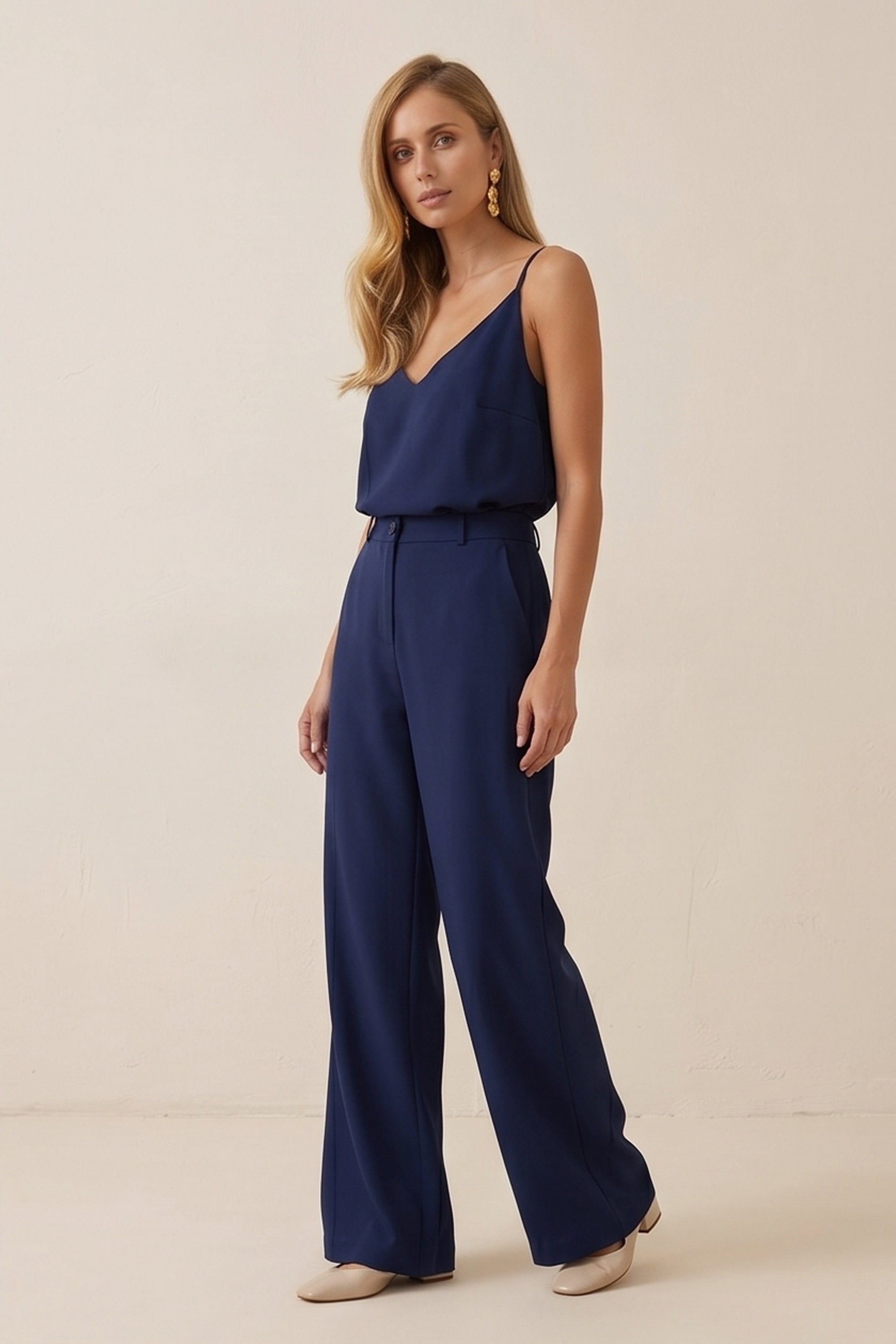 Side view of a woman wearing navy blue Regal Trousers by FemeAdor with high-waisted, wide-leg tailored fit, perfect for professional and casual styling