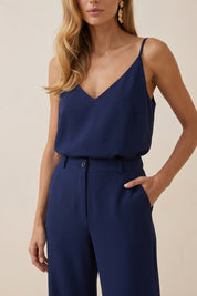 Close up view of a woman wearing navy blue Regal Trousers by FemeAdor with high-waisted, wide-leg tailored fit, perfect for professional and casual styling