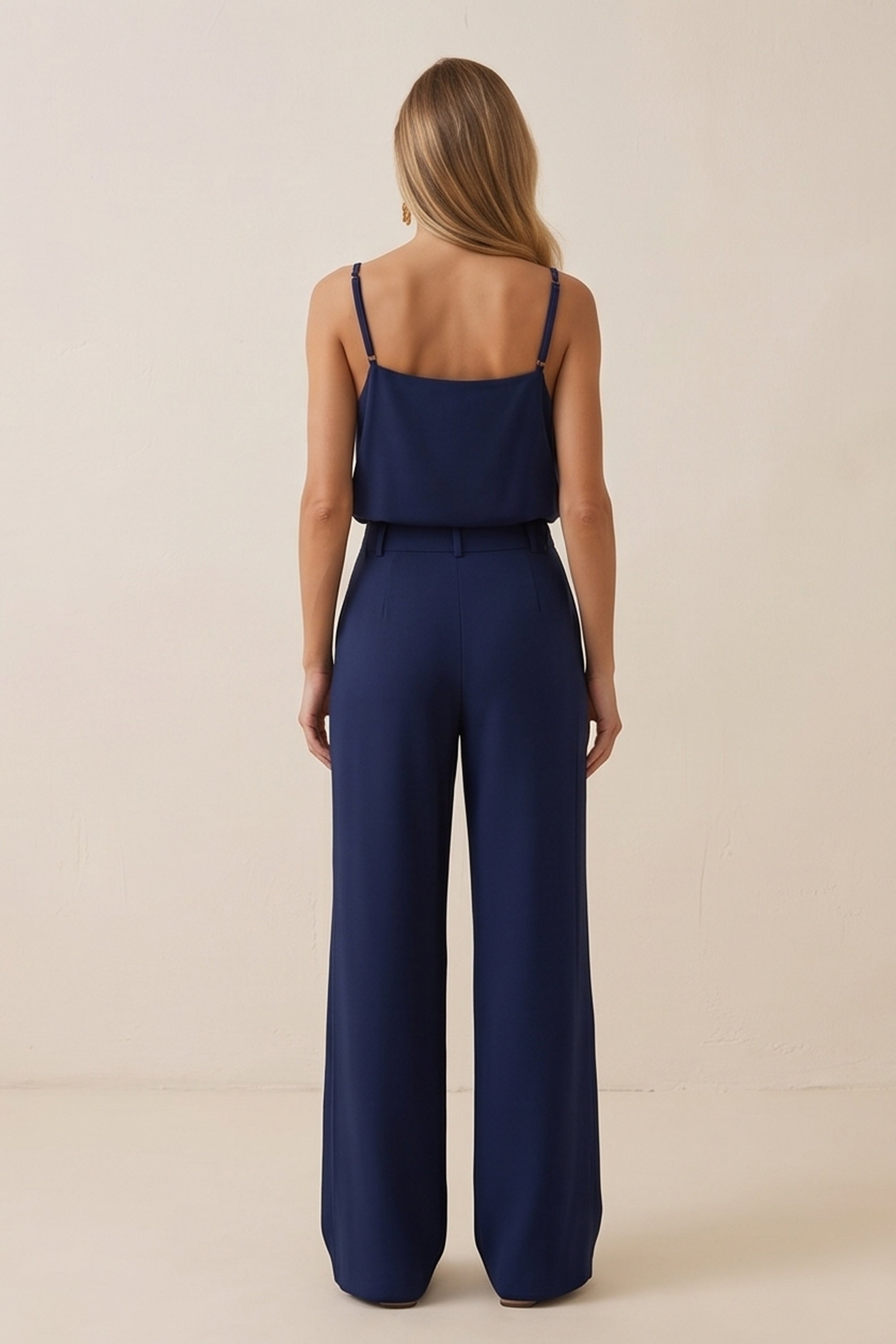 Back view of a woman wearing navy blue Regal Trousers by FemeAdor with high-waisted, wide-leg tailored fit, perfect for professional and casual styling