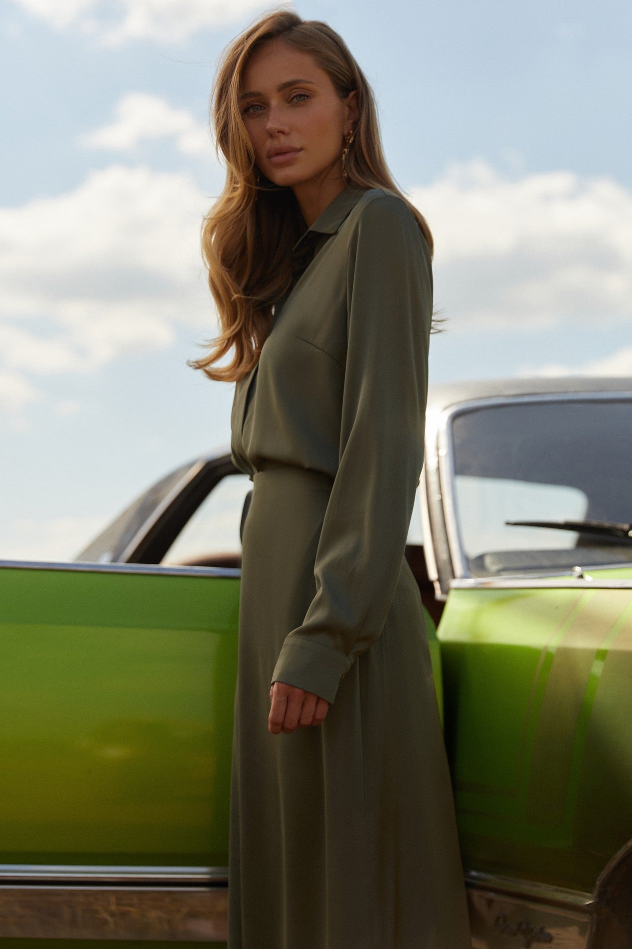 Side view of Nora Blouse in green satin with silk-like sheen and flattering drape, perfect for work or special occasions