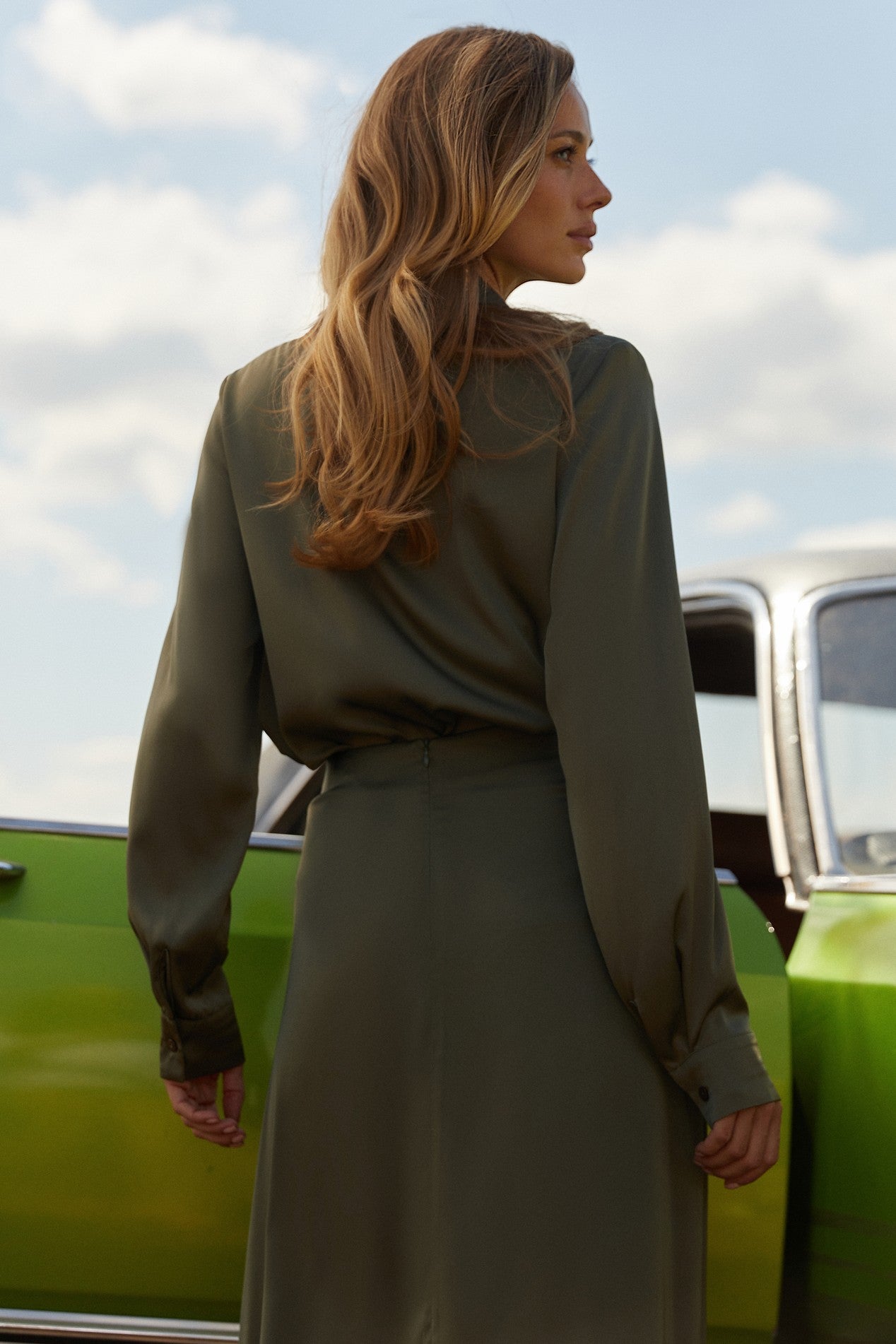 Back view of Nora Blouse in green satin with silk-like sheen and flattering drape, perfect for work or special occasions