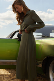 Side view of Nora Skirt by FemeAdor in green featuring a silk-like finish and flattering midi silhouette, ideal for various occasions
