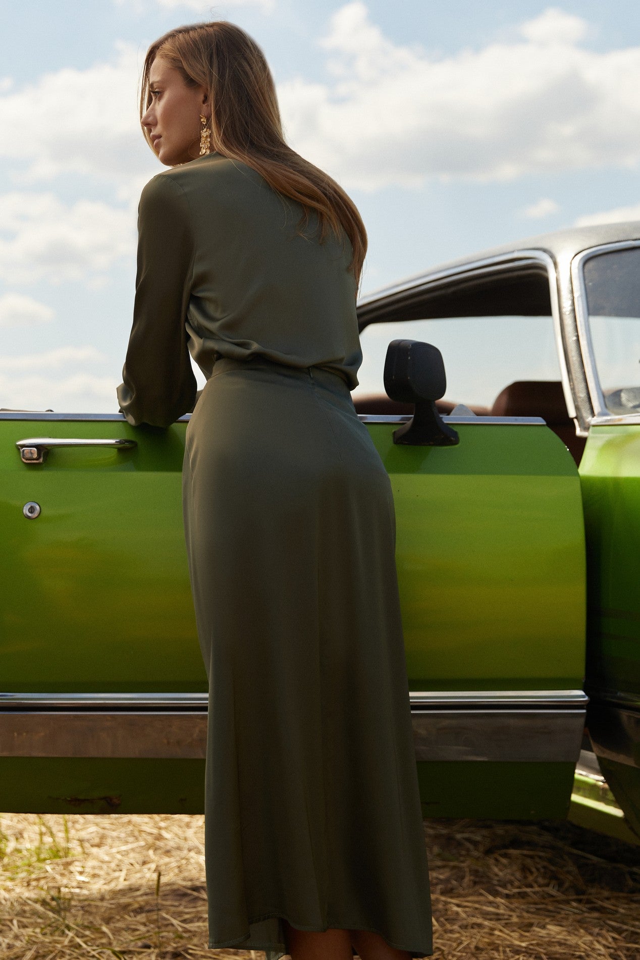 Back view of Nora Skirt by FemeAdor in green featuring a silk-like finish and flattering midi silhouette, ideal for various occasions