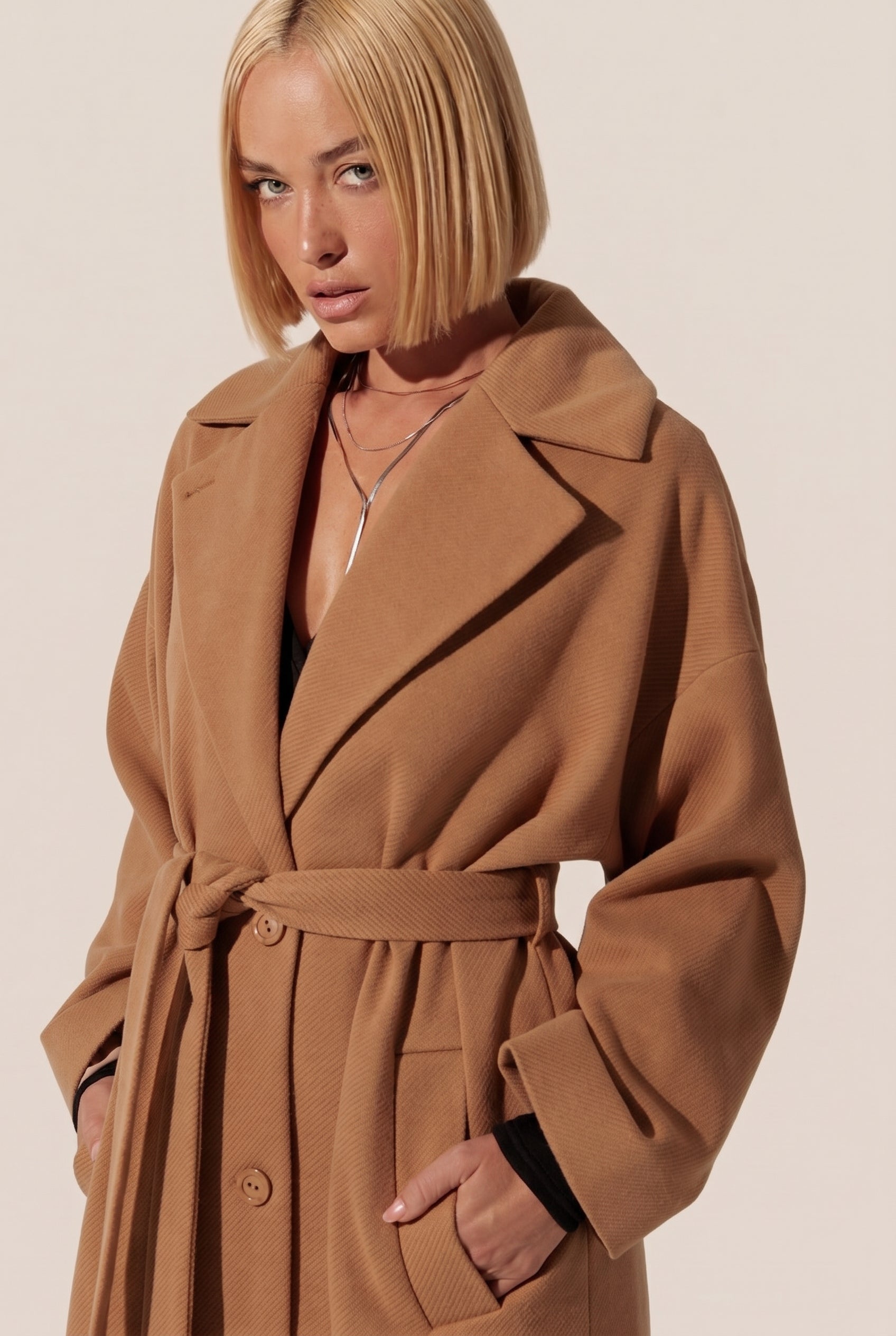 Shop FemeAdor's outerwear collection, featuring a woman wearing the elysian overcoat by FemeAdor.